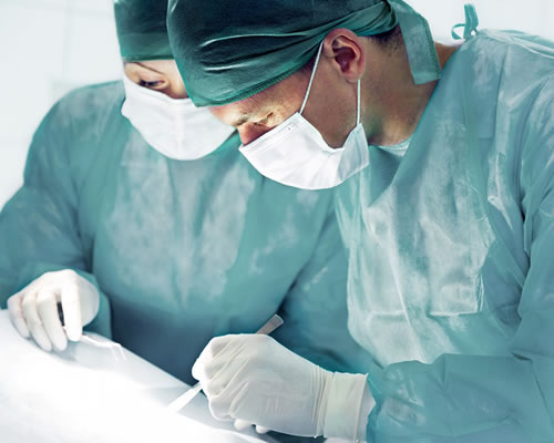 Surgeon performing surgery or procedure in operating room