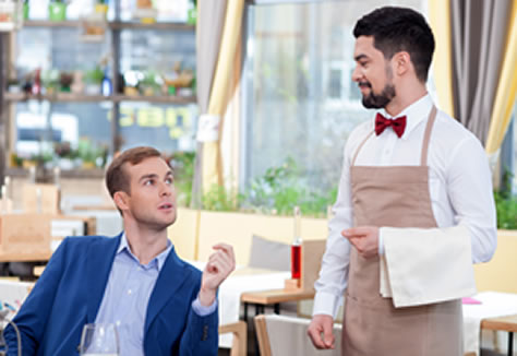 Vegan man asking waiter questions about menu options