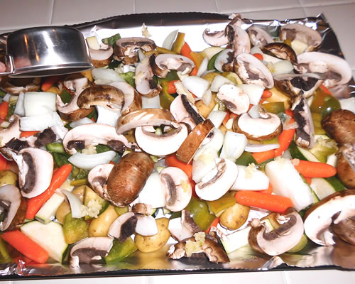 Add all of the ingredients onto a foil-lined baking pan or cookie sheet. Cover and bake at 350 degrees for 20 to 30 minutes or until the vegetables are slightly tender when pierced with a fork.