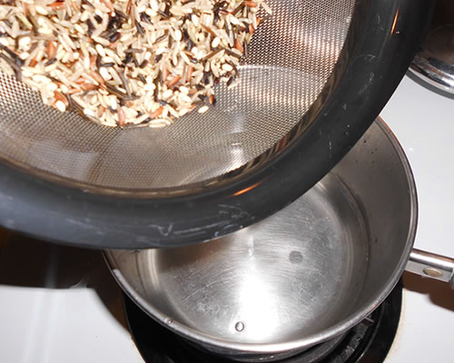 Wash the wild rice; add the rice to boiling water and reduce the heat. Simmer until the liquid is absorbed, approximately 40 minutes.