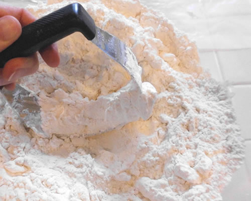 Mix together the flour and salt; cut in the buttery spread.