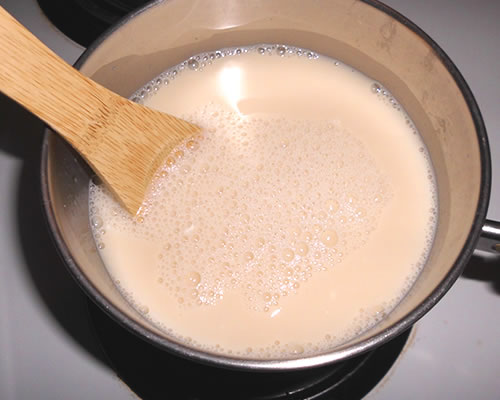 Combine all of the ingredients except for the vanilla in a large pan; let stand for 5 minutes. Cook over medium heat until the mixture comes to a full boil, stirring constantly.