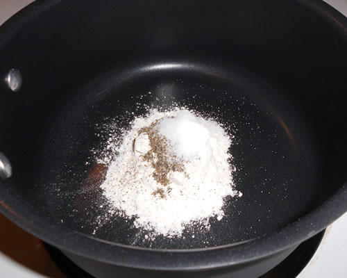In a large saucepan, combine the flour, salt and pepper.