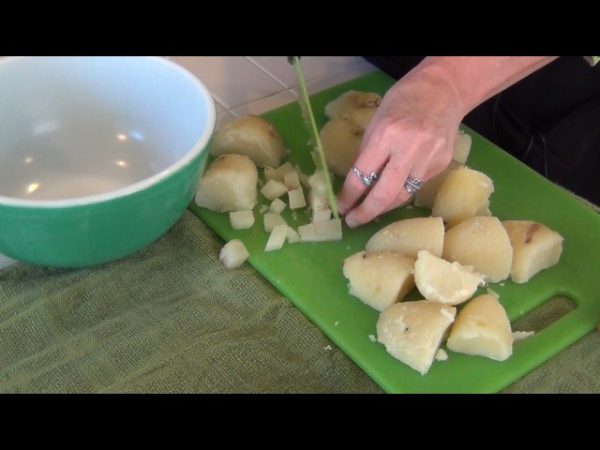 Peel and boil the potatoes; cool and cut into cubes.