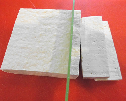Prepare the tofu; slice the tofu into 1/2 to 3/4 inch slices.