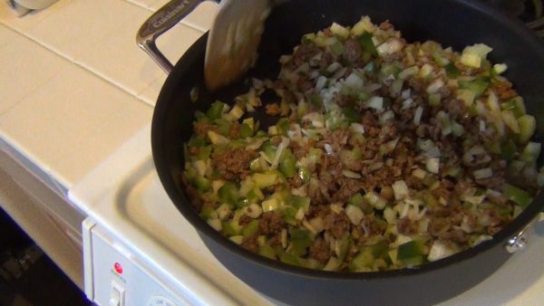 Heat the oil in a large pan; saute the crumbles, onion, bell pepper, celery and garlic for approximately 5 to 10 minutes or until the vegetables are semi-cooked.