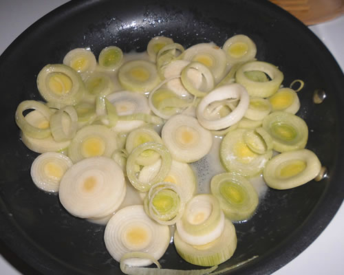 In a small pan, saute the first two ingredients for approximately 20 minutes or until the leeks are tender.