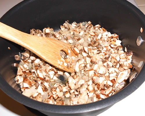 In a medium pan, saute the mushrooms and onions in the buttery spread on medium high heat until tender.