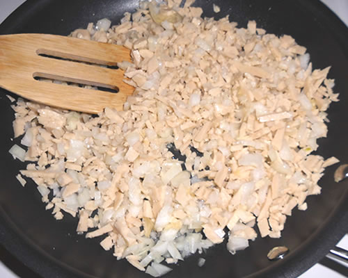 In a large pan, saute the chicken cutlets, onions, and garlic in the olive oil until the vegetables are tender; add the spices.