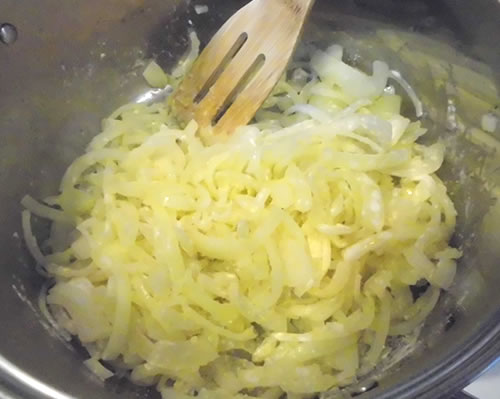 In a large pan, heat the oil over medium heat; add the onions and cook for 2 minutes. Add the flour and stir to coat the onions.