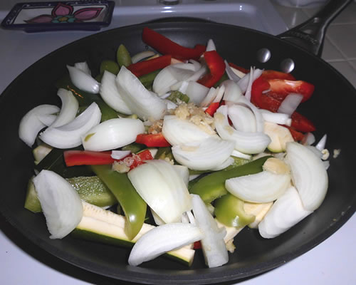 In a large pan, saute the vegetables in the olive oil for 5 to 10 minutes over medium high heat.