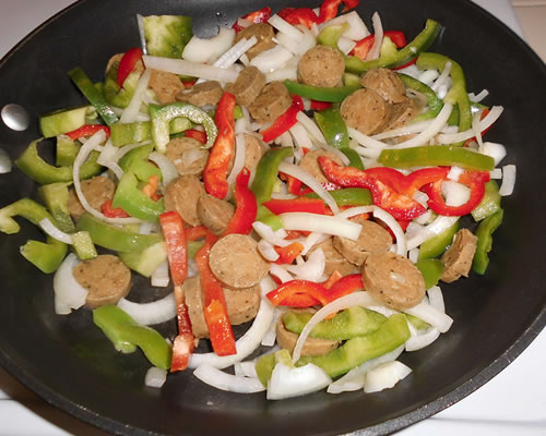 In a large pan, saute the sausage, bell pepper, onion and garlic in the oil over medium heat for 10 to 15 minutes or until the vegetables are slightly tender.