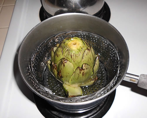 Steam the artichoke until it is tender and its leaves can be easily removed; sprinkle with the salt and black pepper.