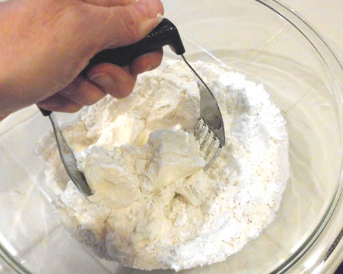 Cut the butter into the dry ingredients (powdered sugar and flour); press into an 8 x 8-inch baking pan (ungreased), and bake at 350 degrees for 20 to 25 minutes or until lightly browned.