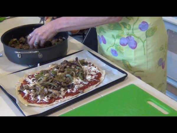 Spread the marinara sauce onto the prepared pizza crust; top with the sausage mixture, olives, and cheeses; bake at 375 degrees for 10 minutes or until the crust is lightly browned.