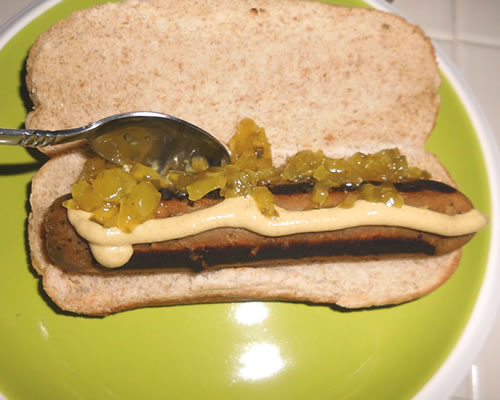 Add the sausage / dog to each bun; top with 1 teaspoon each of relish and mustard.