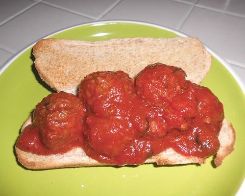Add 1/3 cup of the pasta sauce and halved meat balls to the lightly toasted hoagie bun.