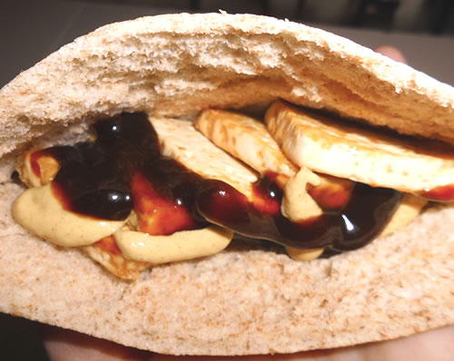 Cut the pita bread into halves (pockets); place 4 to 5 tofu squares into each pocket; add 1/2 tablespoon each of the mustard and hoisin sauce into the pita pockets.