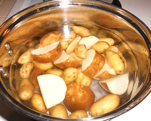 In a separate pan, boil the potatoes until tender, approximately 10 minutes.