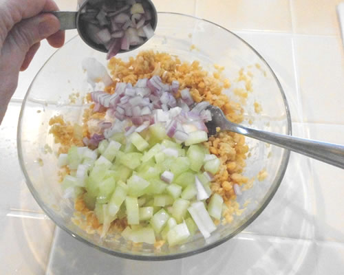 Add the remaining ingredients, mixing until combined; chill and serve on lettuce with tomatoes.