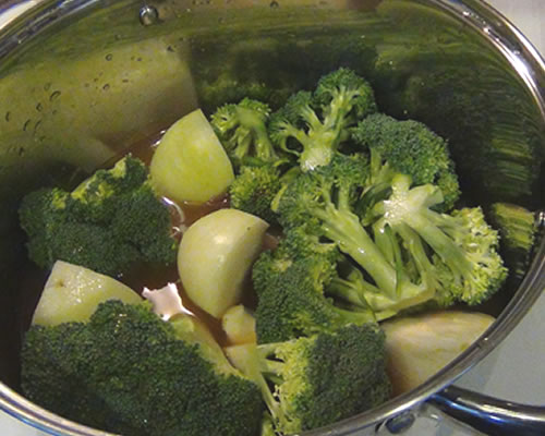 In a large pot, bring the first four ingredients to a boil. Reduce the heat to medium and cook for approximately 15 minutes or until the vegetables are tender.