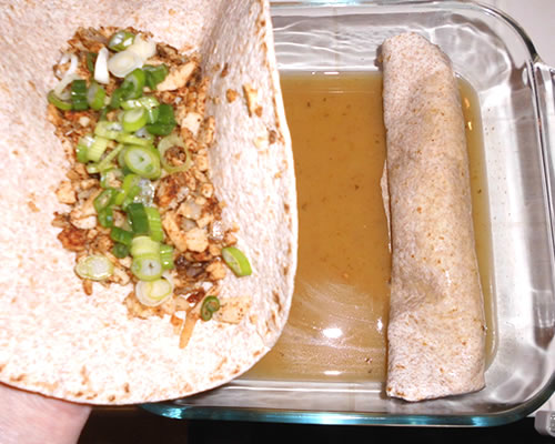 Fill the tortillas with the chicken mixture; add the cheddar cheese and green onions, and roll the tortillas lightly.