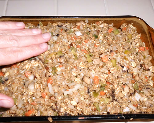 Pat the mixture into a greased loaf pan; bake at 350 degrees for 60 minutes or until lightly browned. Allow to cool / stand for 10 minutes before serving.