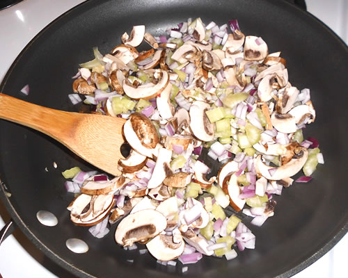 In a large pan, saute the onion, celery, mushrooms and garlic in the olive oil until tender.