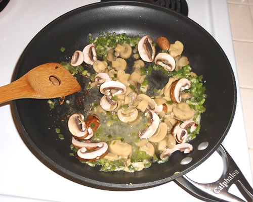 In a large pan, saute the onion, parsley, bell pepper, mushrooms, and garlic in the buttery spread over medium heat for approximately 5 to 10 minutes, stirring frequently.