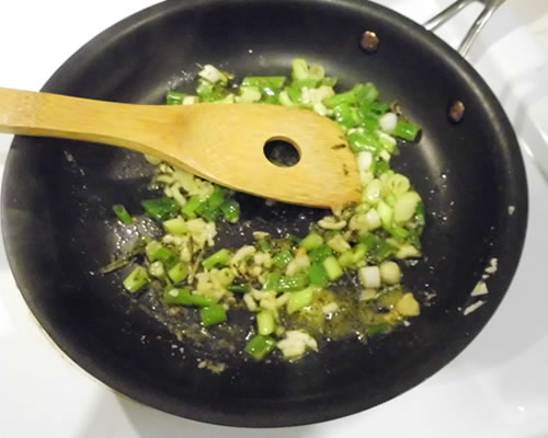 In a medium pan, heat the olive oil and saute the green onions, garlic, tarragon and dry mustard for three minutes. Remove from the heat and add the remaining ingredients, stirring until blended.