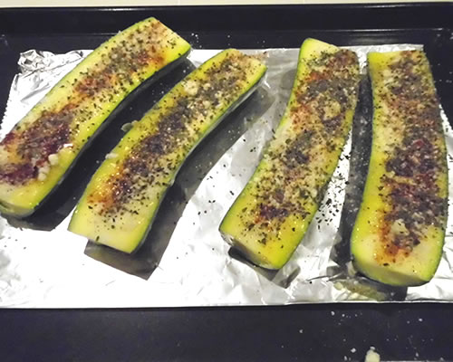 Sprinkle the remaining ingredients over the zucchini halves; bake at 375 degrees for 15 to 20 minutes or until slightly tender when pierced with a fork.