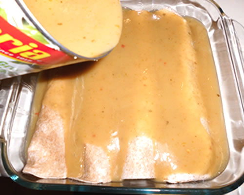Line the bottom of a baking dish with some of the sauce. Add the rolled tortillas to the dish, and top with the remaining sauce. Bake (covered) at 350 degrees for 30 minutes or until the enchiladas are heated through and the sauce is bubbly.