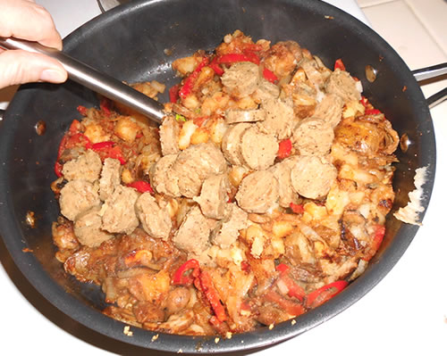 Add the sausage and the cheese to the mixture, and continue cooking / heating through.