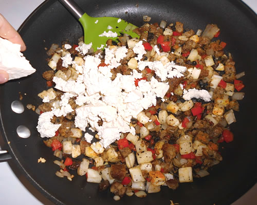 Add the potatoes, sausage and spices; add the crumbled tofu and cook over medium low heat until well combined and heated through.
