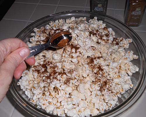 Sprinkle the Parmesan cheese and spices over the popcorn; toss until evenly distributed.