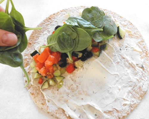 Add the vegetable mixture to the tortilla; add the tomatoes and lettuce / spinach, and roll the tortilla.
