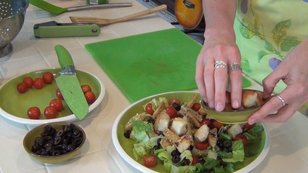 On separate plates, assemble the salad (lettuce, tomato, red onion and black olives); add the chicken and croutons.