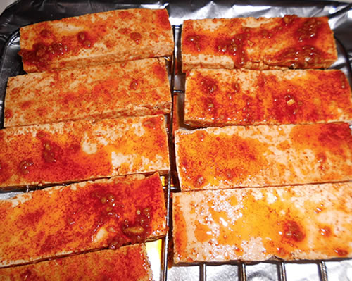 Barbecue or broil / grill the tofu steaks until they are browned on each side, brushing them with additional cajun sauce.