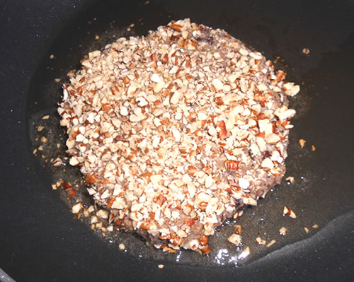 In a shallow bowl or pie plate, coat the patties in the pecans; add the oil to a large pan and cook the patties for approximately 5 minutes on each side or until brown, and drain on paper towels.