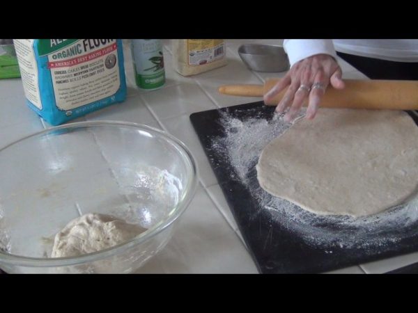 Punch down the dough; roll out the dough and spread it onto cookie sheets / pizza pans coated with non-stick cooking spray and sprinkled with the cornmeal. Cover the dough and allow it to rise for another 30 minutes.