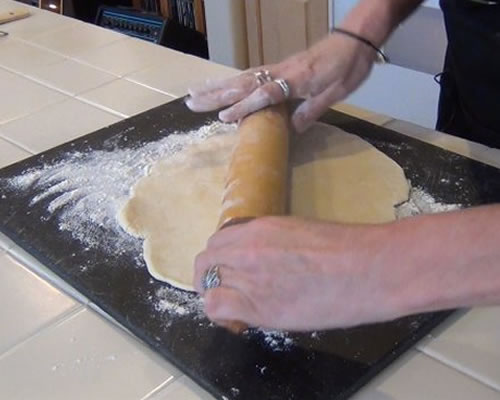 Flatten the dough ball onto a floured pastry cloth or board; roll the pastry two inches larger than an inverted pie plate.