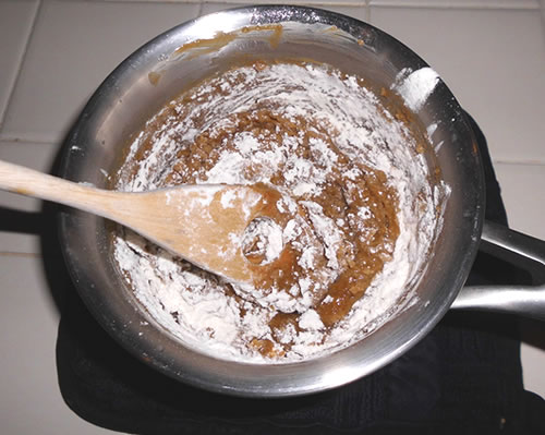 Add the dry ingredients to the buttery spread mixture; add the peanuts and chocolate cihps and stir until well blended.