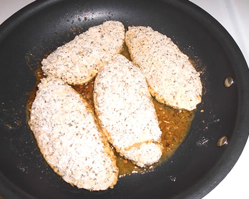 In a large pan, heat the olive oil; cook the cutlets in the pan over medium heat until lightly browned on both sides.