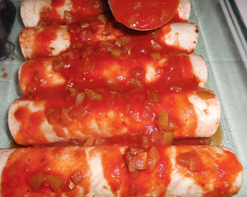 Pour the remaining sauce over the enchiladas and bake uncovered at 350 degrees for approximately 20 minutes or until the sauce is bubbly.
