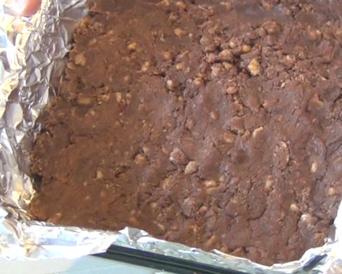 Spread the fudge into a foil-lined 8 x 8-inch baking pan; chill until set. Turn out of the pan, peel off the foil, and cut into 1" squares.
