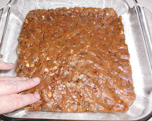 Turn the dough into an 8 x 8-inch baking pan (greased); bake at 350 degrees for 25 minutes or until lightly browned on the bottom. Cool and cut into squares.
