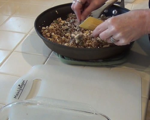 Stuff the uncooked manicotti shells with the crumble mixture and place the filled shells in the baking pan.