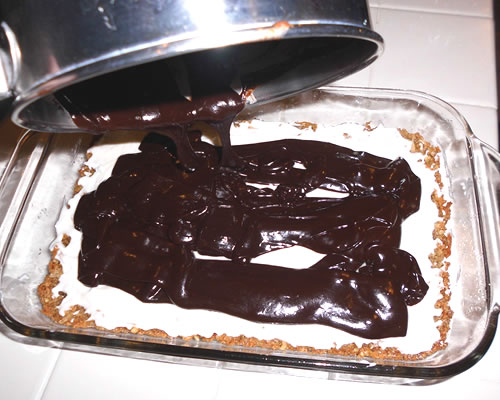 For the frosting, melt the chocolate chips and buttery spread at the top of a double boiler; spread the chocolate frosting over the top of the rum filling. Chill and cut into 1-inch squares.