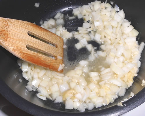 In a large pan, melt the buttery spread. Add the onions and garlic, and cook until tender, approximately 10 minutes.