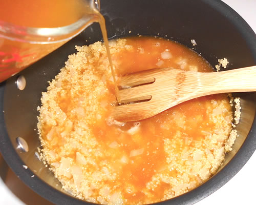 Stir in the couscous and vegetable broth; bring to a boil. Remove from the heat, cover and allow to stand for 5 minutes.